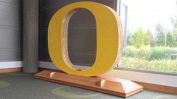 Yellow O on a large wooden base