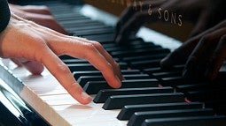 Hands playing a piano Hands playing a piano