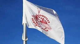 Flag of the Coquille Indians flying outside the EMU