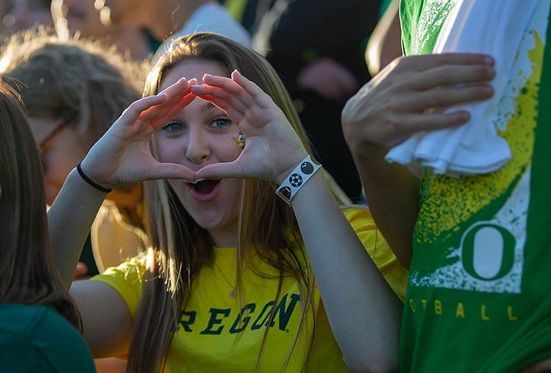 A UO student makes the O shape with their hands