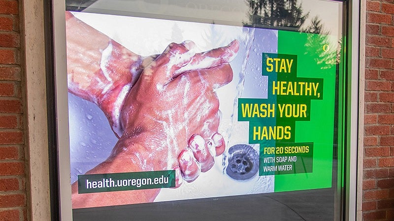 Photo of digital signage showing a slide about hand washing