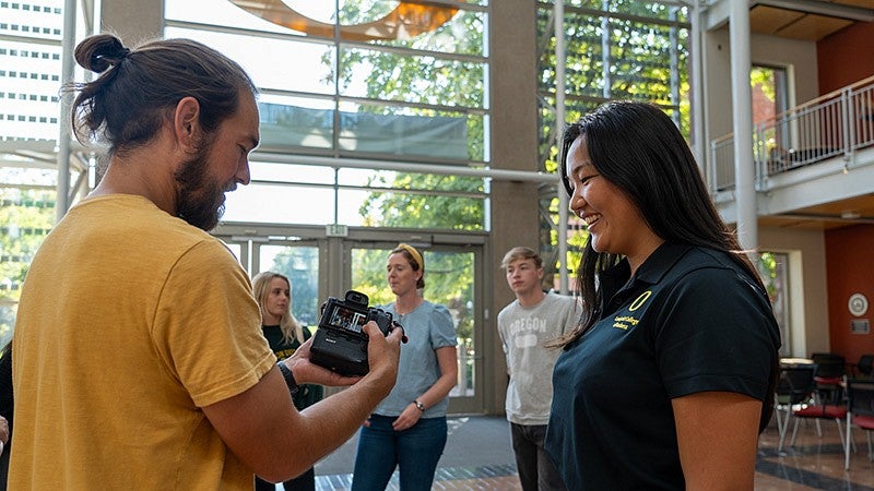 a photographer showing a camera image to another person