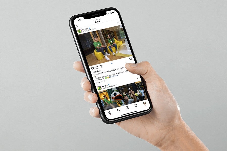 someone looking at the UO instagram on their phone