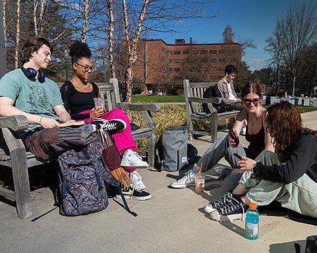 students sitting outside on campus