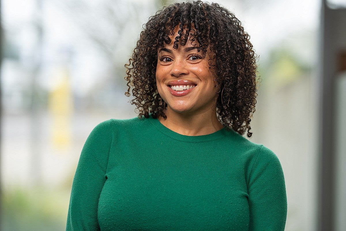 Headshot of employee in a green sweater