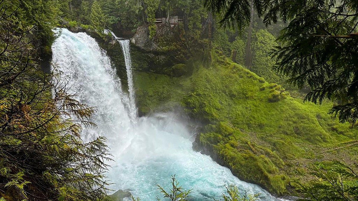 waterfall among green mossy rocks