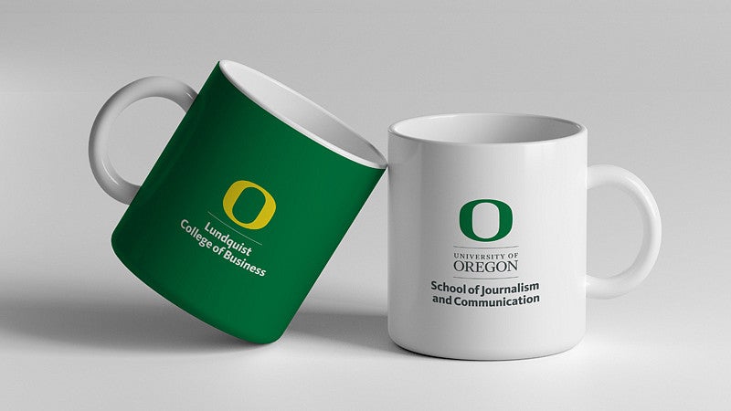 Two mugs adorned with departmental logos