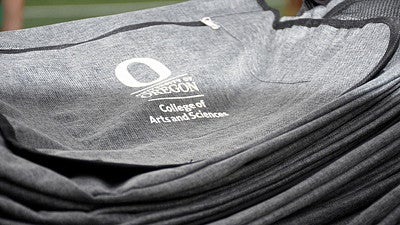 grey shoulder bag with college of arts and sciences departmental logo on it