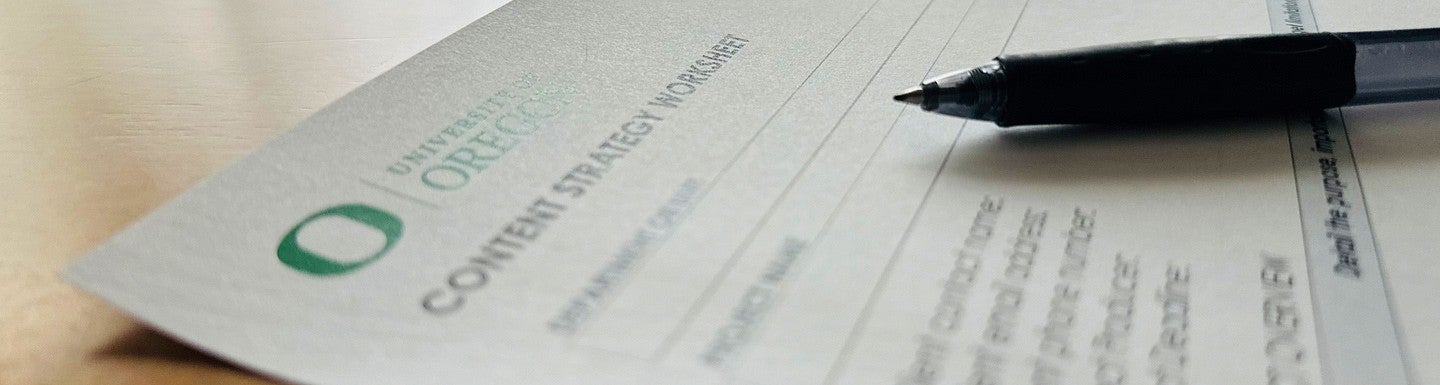 close-up photograph of a portion of the content strategy worksheet with a pen