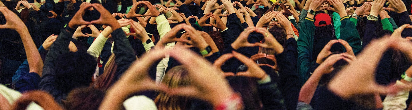 crowd of hands each forming the Oregon O