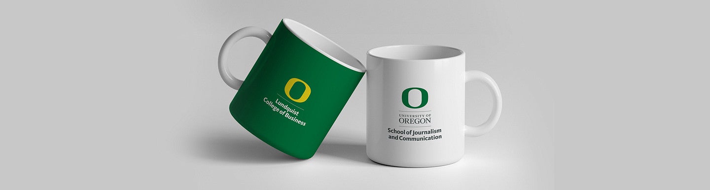 Two mugs adorned with departmental logos