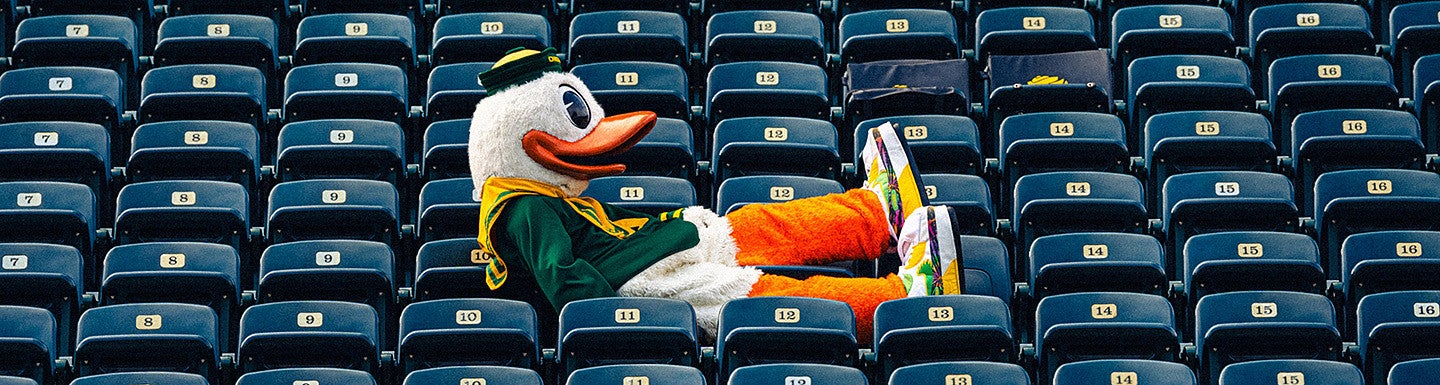 Oregon Duck lounges in the empty seats of a stadium