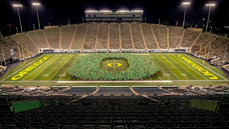 UO students on Autzen Stadium turf forming the O