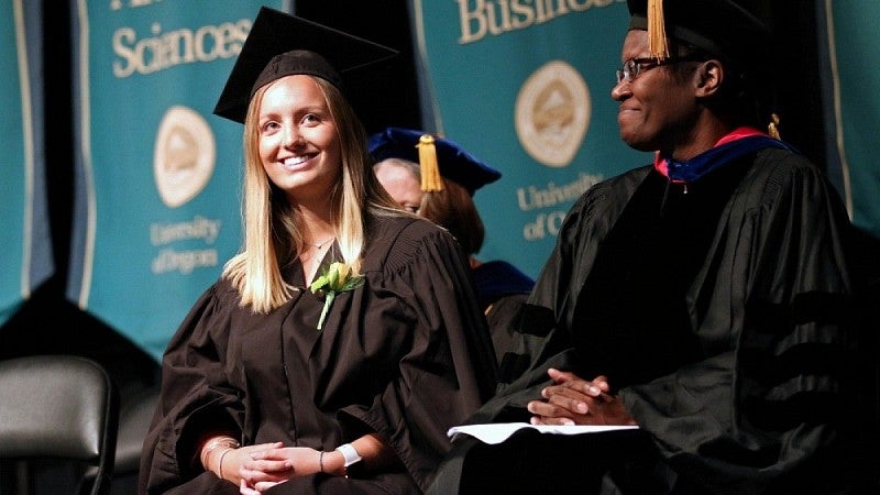 Female UO graduate on stage at convocation