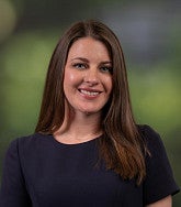 Professional portrait of person with greenery in background